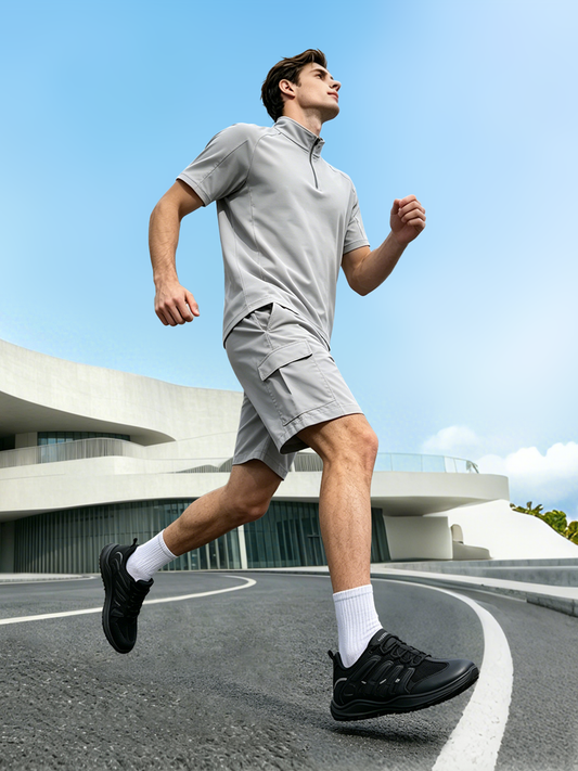 A man is running in the gym wearing black running shoes